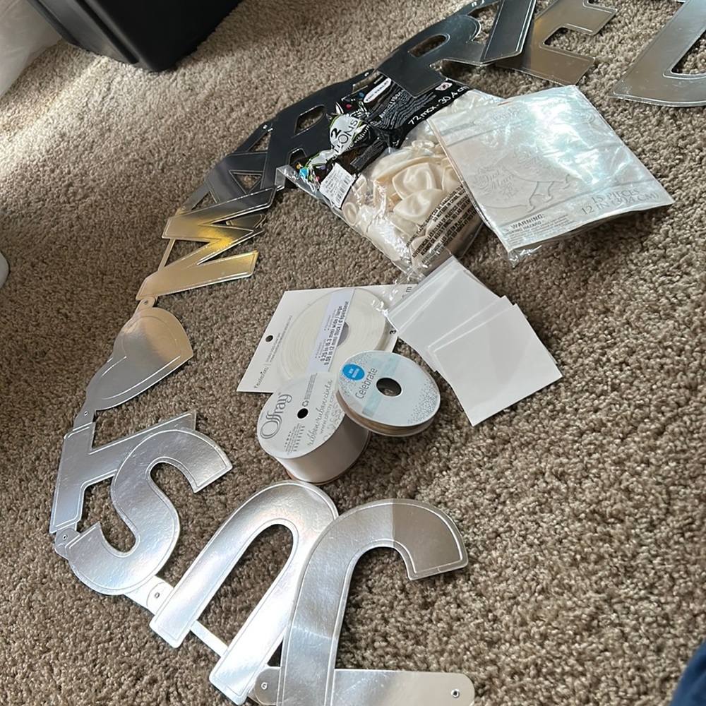 Wedding party supplies: just married sign, balloons, ribbon, adhesive